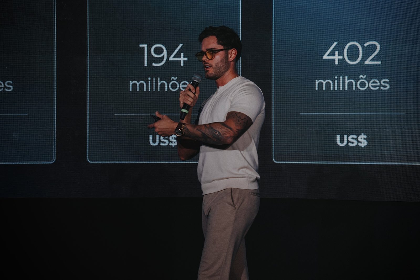 Thomas Macedo no palco apresentando os números do mercado global de IA